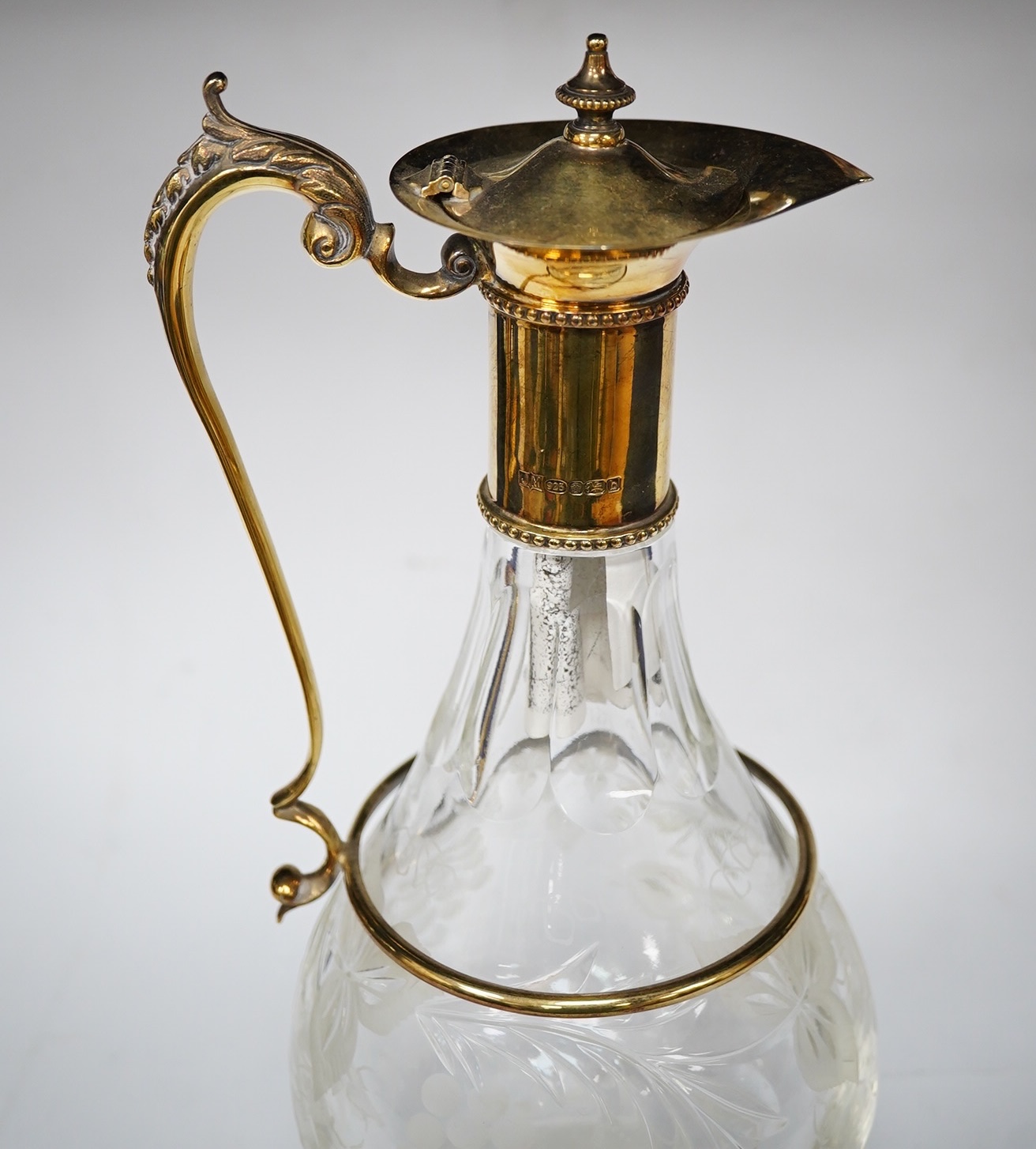 A modern silver gilt mounted cut glass pyriform claret jug, maker JM, Sheffield, 2001, 31.2cm. Condition - good